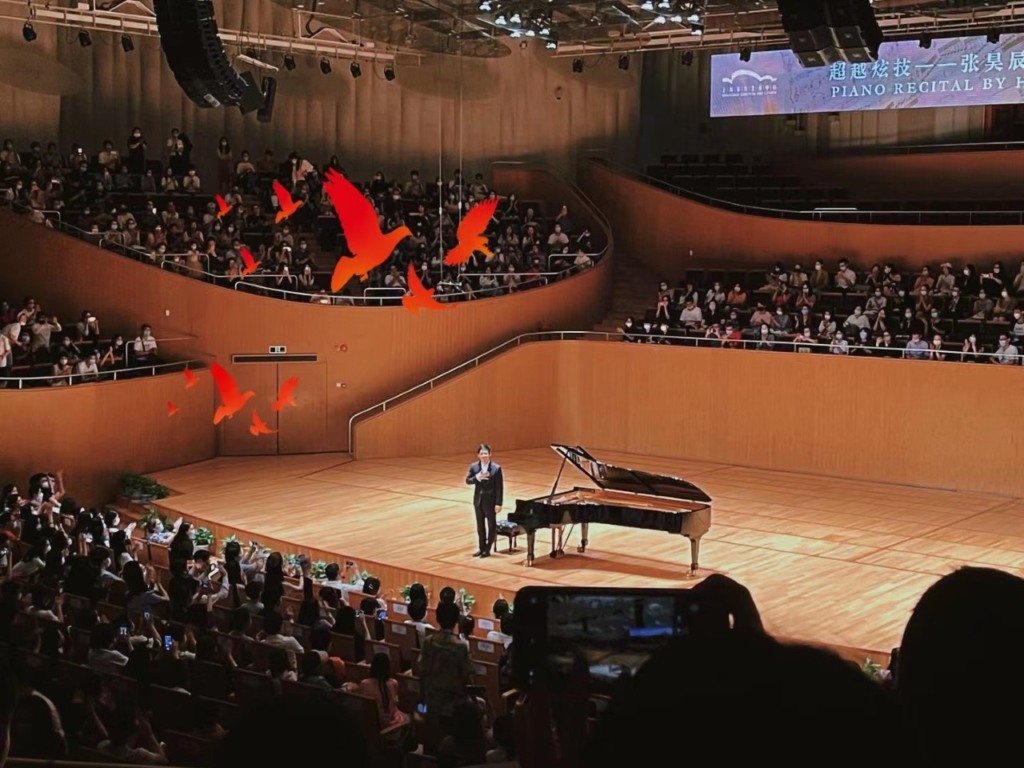 A picture containing indoor, watching, auditorium, crowd

Description automatically generated